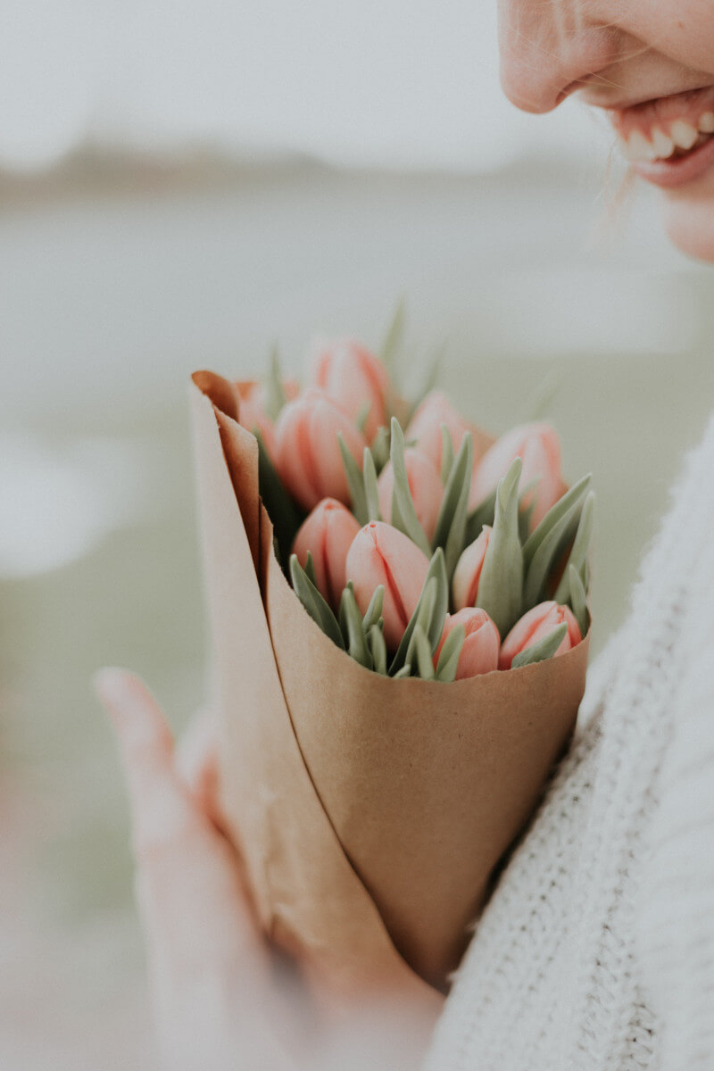 Das-ist-inkludiert Frau mit Blumenstrauß in den Händen